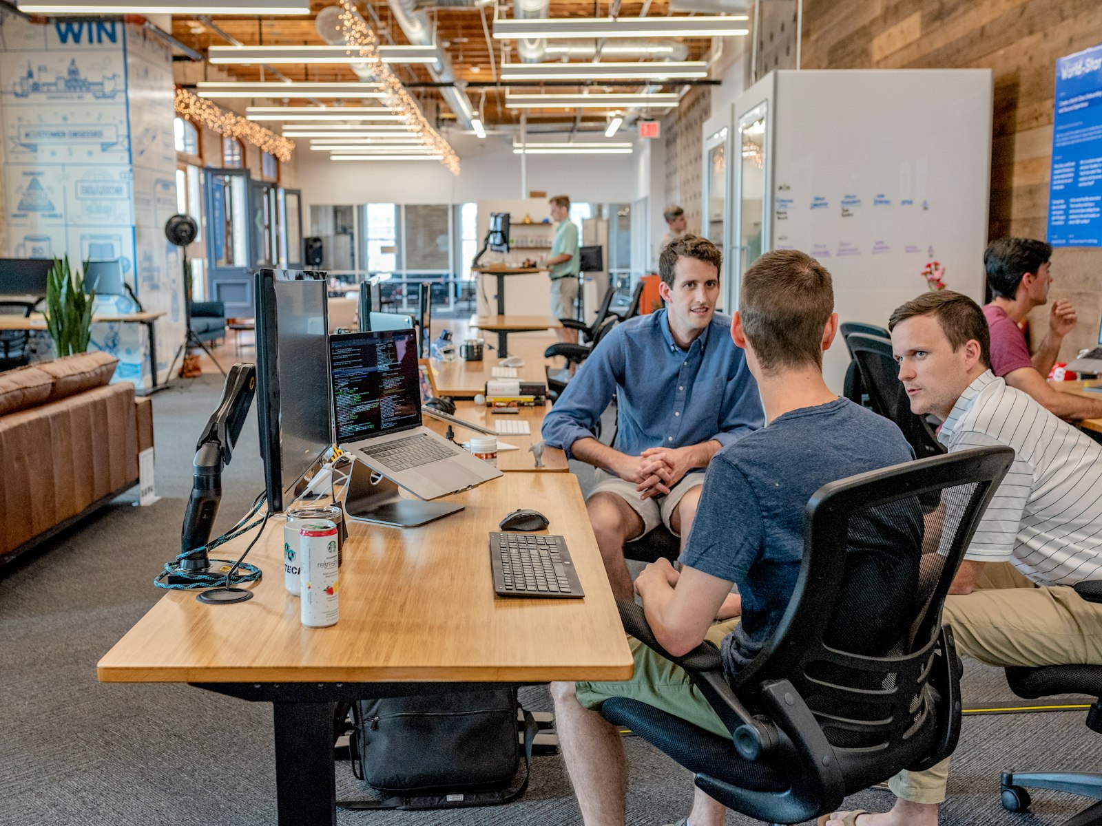 A studio team talking through work at their desks