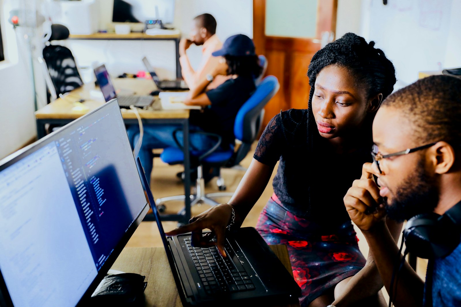 Two founders forming their venture together at a laptop